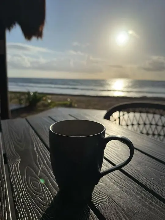 Morning coffee by the sea at sunrise